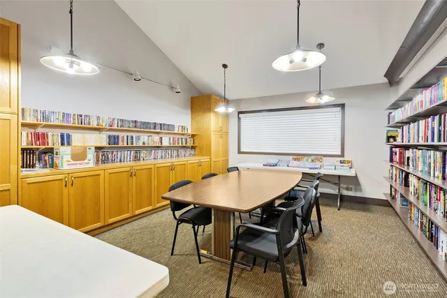 a dining room with stainless steel appliances kitchen island a table and chairs