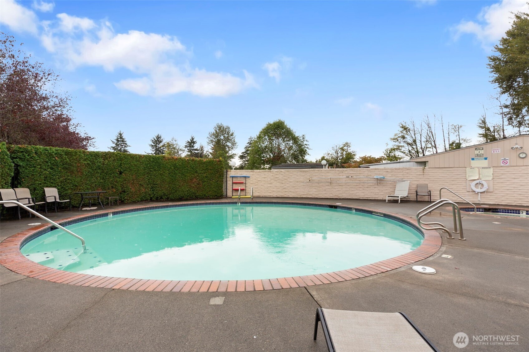 3611 I Street Northeast, Unit 424 Auburn, WA 98002 - Photo 32 of 34 a view of a swimming pool with a yard and sitting area