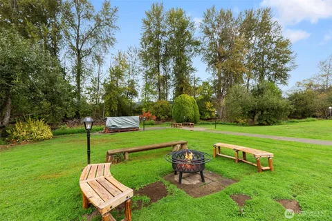 a view of a park with bench and trees