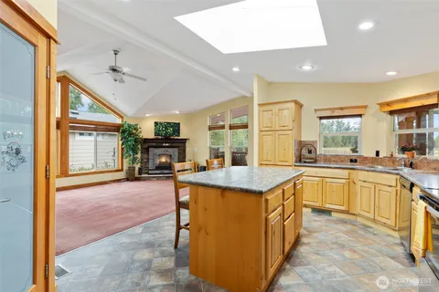 a kitchen with kitchen island a sink stove and wooden cabinets