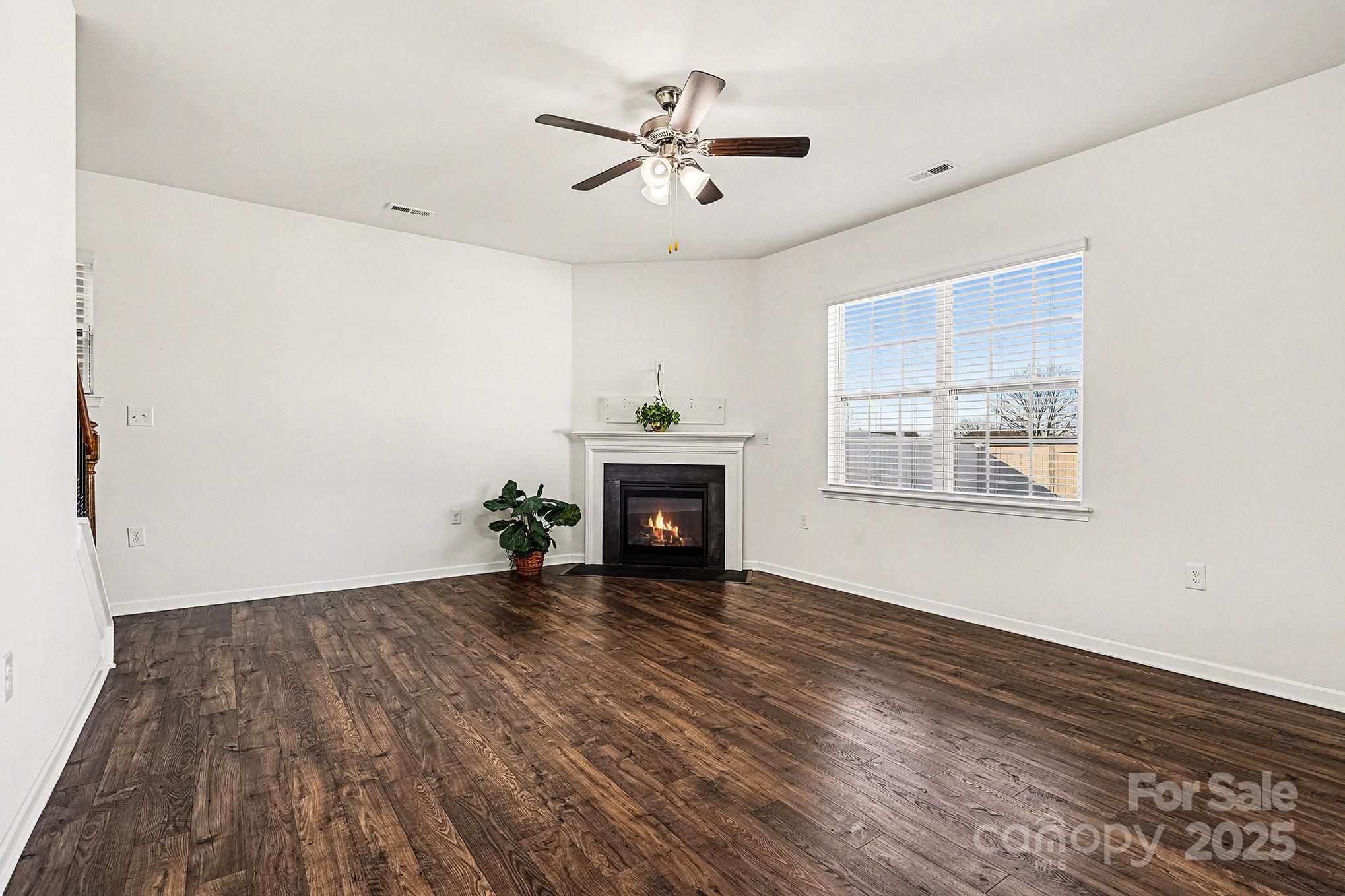 3224 Hawksbill Street Southwest Concord, NC 28027 - Photo 13 of 35 wooden floor in an empty room with a fireplace