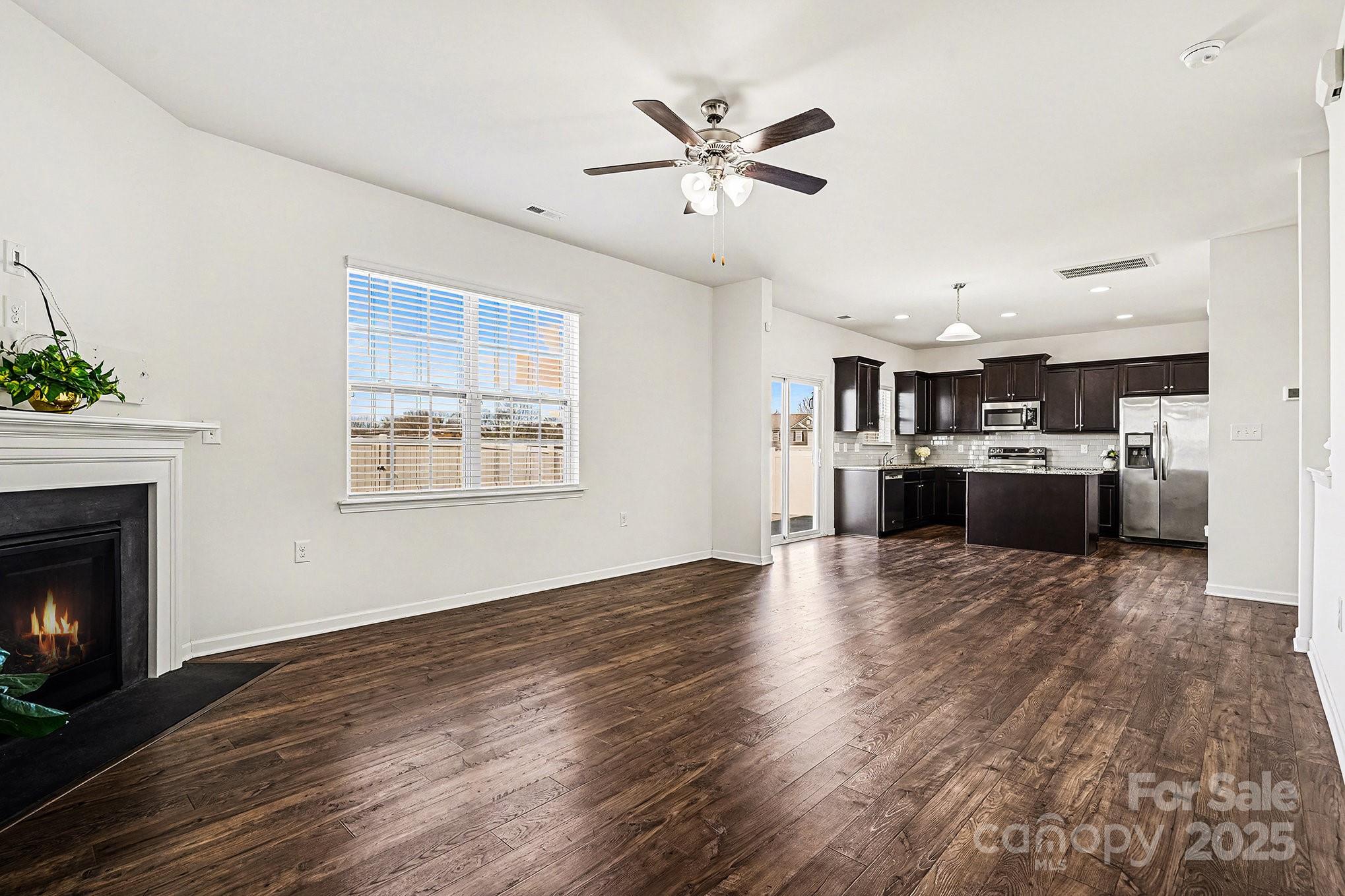 3224 Hawksbill Street Southwest Concord, NC 28027 - Photo 14 of 35 a view of a kitchen with a stove wooden cabinets and entryway