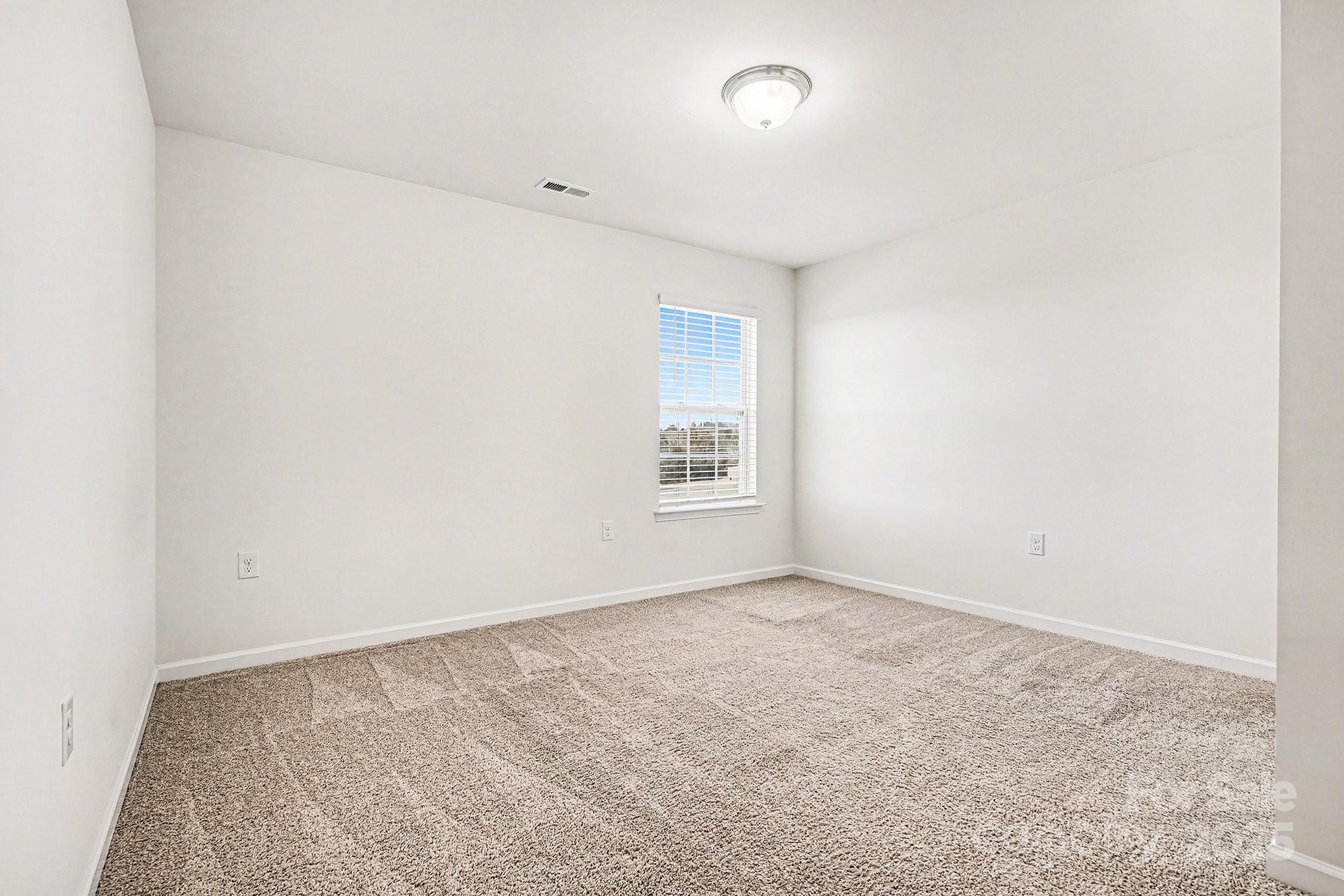 3224 Hawksbill Street Southwest Concord, NC 28027 - Photo 16 of 35 an empty room with a natural light