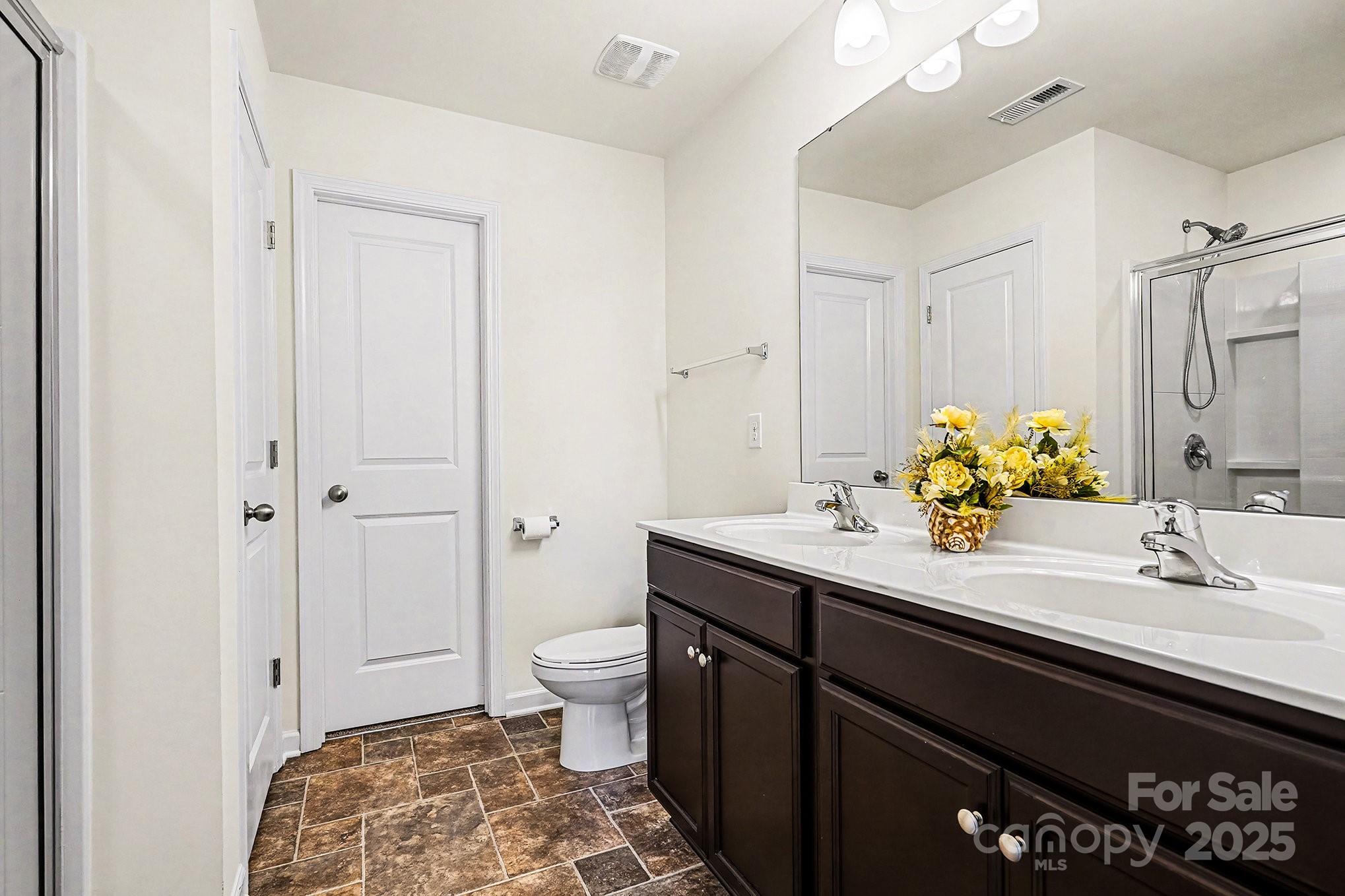 3224 Hawksbill Street Southwest Concord, NC 28027 - Photo 20 of 35 a bathroom with a sink and a mirror