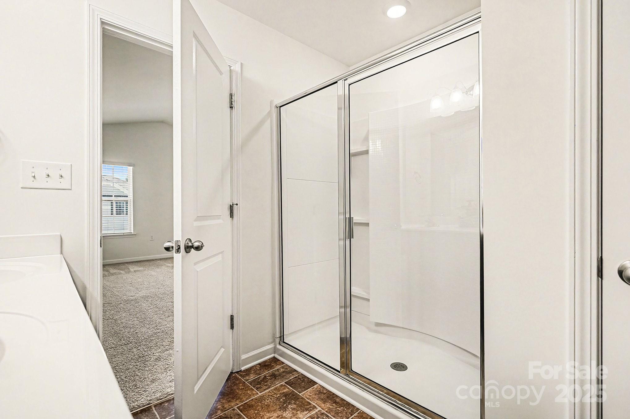 3224 Hawksbill Street Southwest Concord, NC 28027 - Photo 21 of 35 a bathroom with a glass shower door