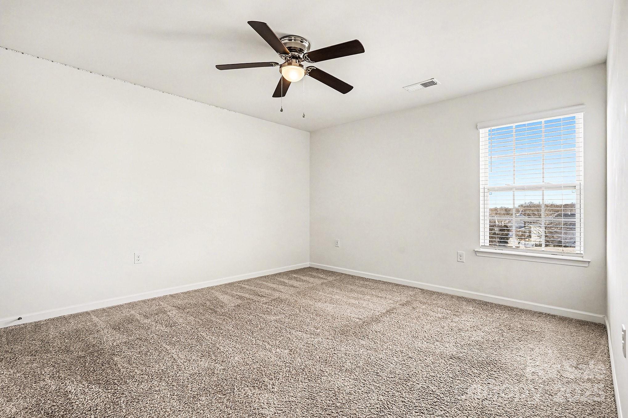 3224 Hawksbill Street Southwest Concord, NC 28027 - Photo 23 of 35 an empty room with ceiling fan and window