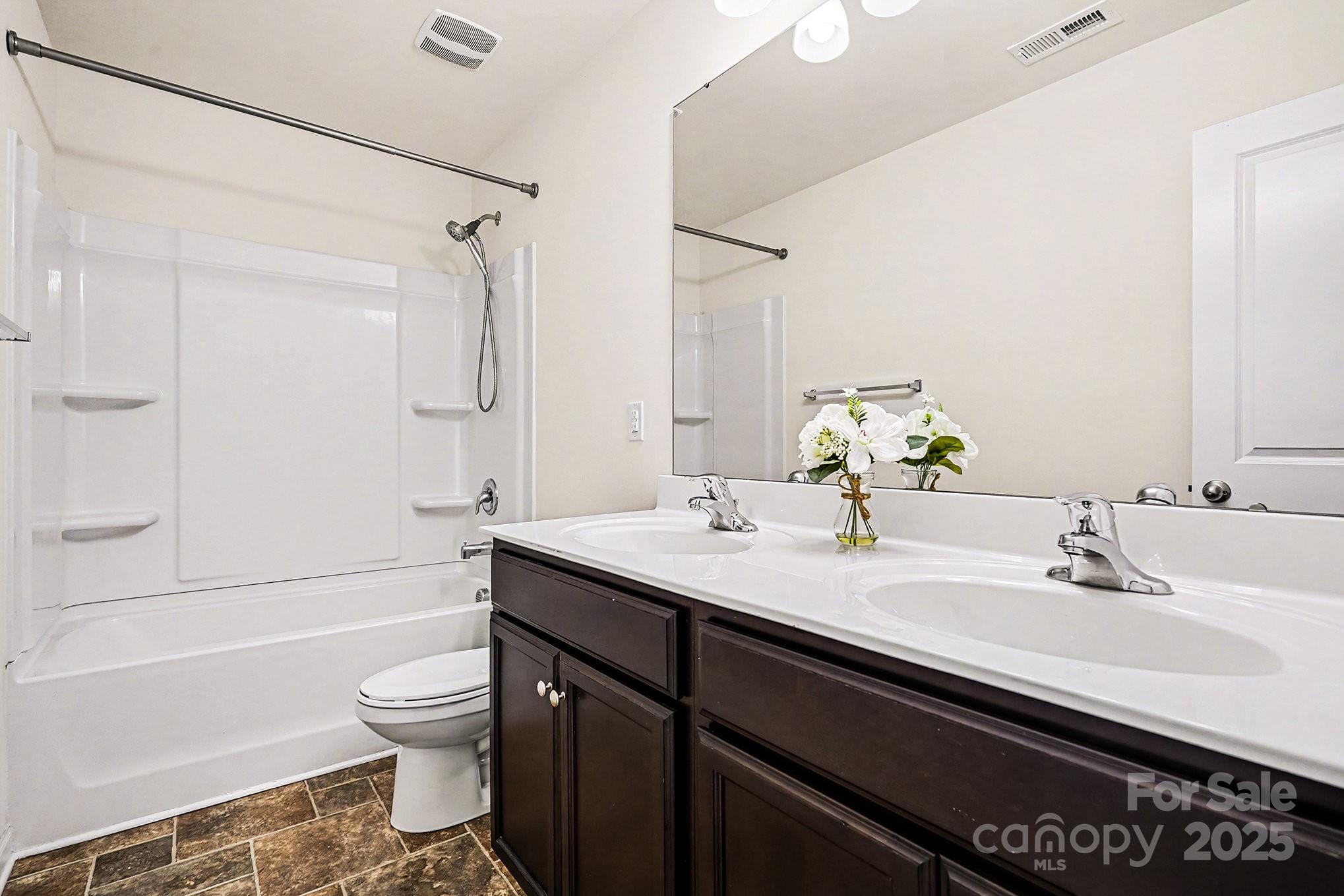 3224 Hawksbill Street Southwest Concord, NC 28027 - Photo 24 of 35 a bathroom with a sink a toilet and shower