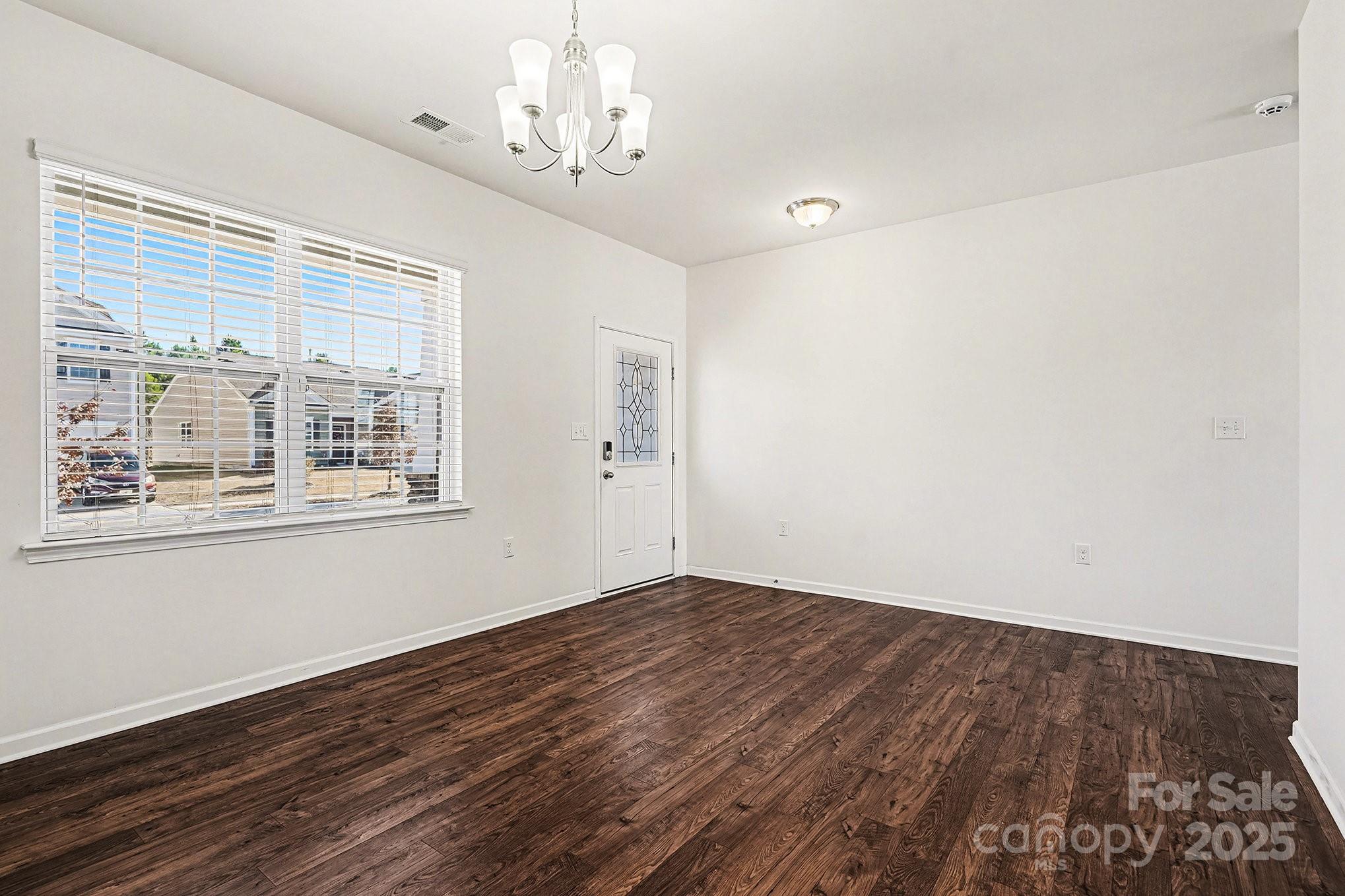 3224 Hawksbill Street Southwest Concord, NC 28027 - Photo 6 of 35 a view of empty room with wooden floor and fan
