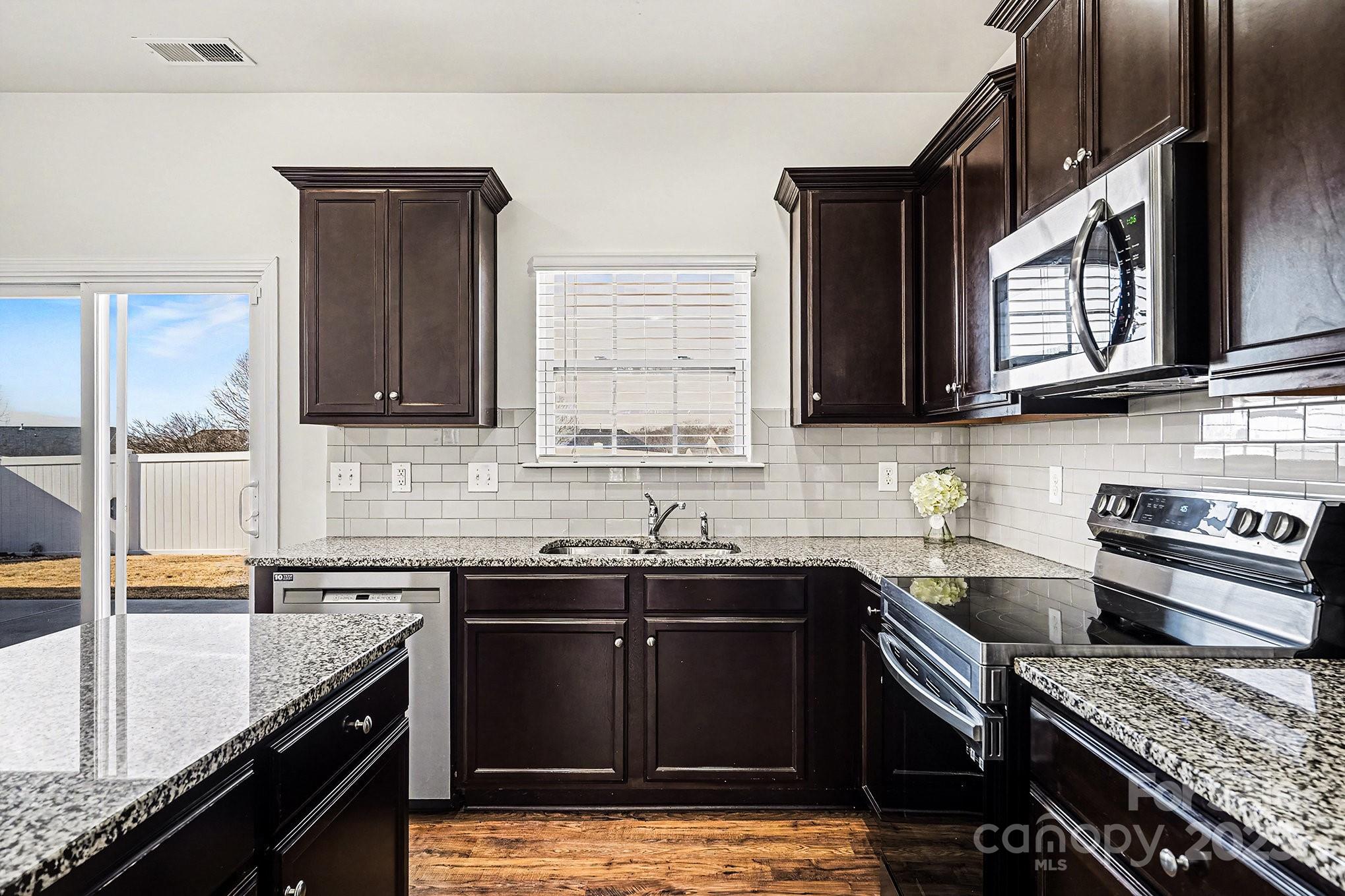 3224 Hawksbill Street Southwest Concord, NC 28027 - Photo 8 of 35 a kitchen with a sink stove top oven and cabinets