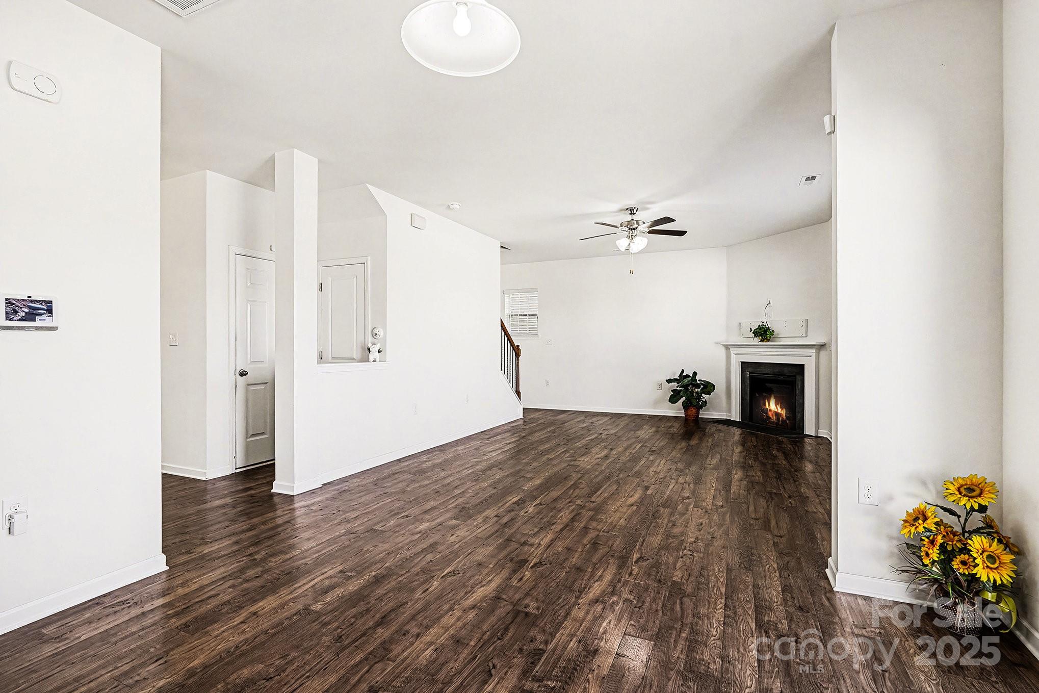 3224 Hawksbill Street Southwest Concord, NC 28027 - Photo 10 of 35 a view of a living room a fireplace and wooden floor
