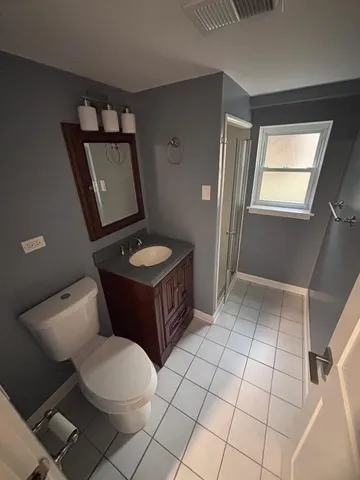 a bathroom with a sink a toilet and mirror