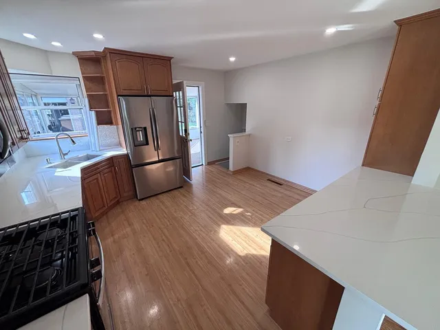 a kitchen with stainless steel appliances refrigerator microwave and stove