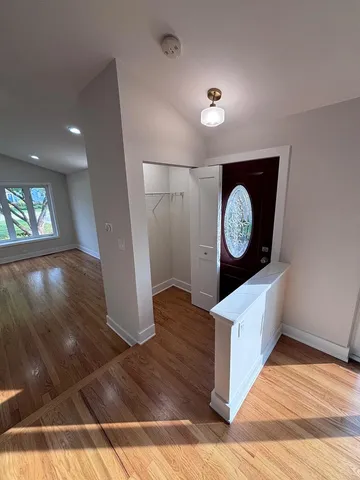 a view of a hallway with wooden floor
