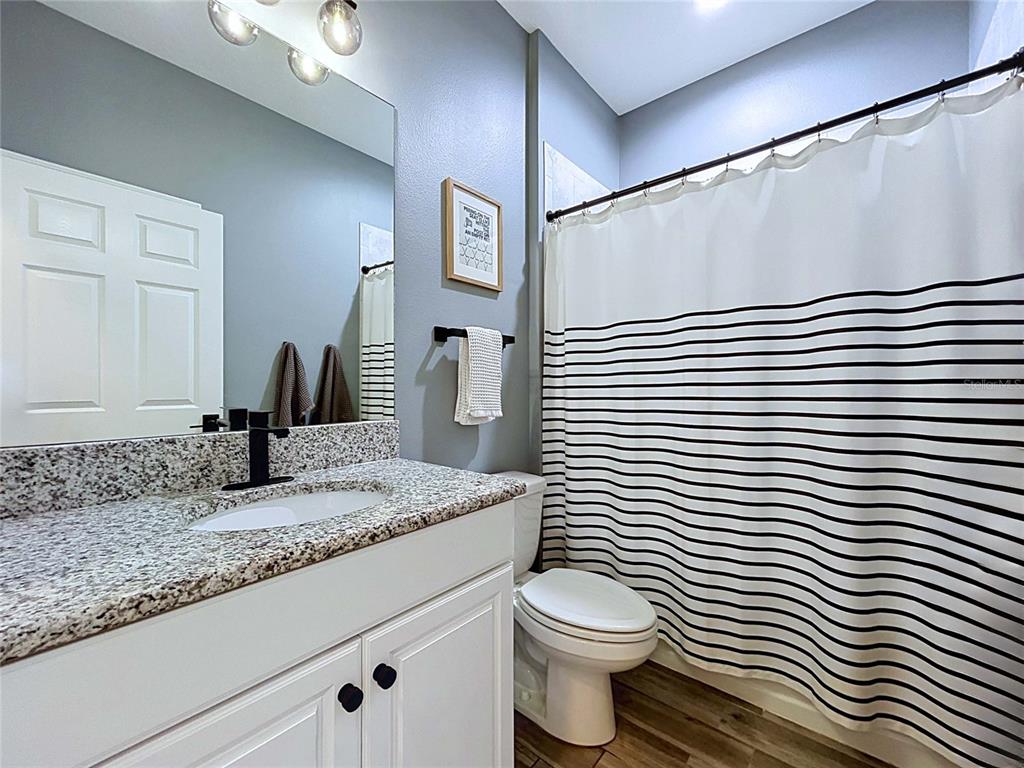 18078 Romanesque Court Spring Hill, FL 34610 - Photo 47 of 81 a bathroom with a granite countertop sink toilet and mirror