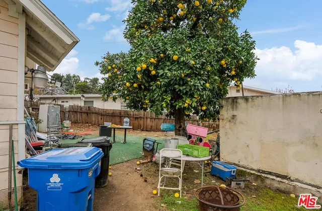 a backyard of a house with seating space and stainless steel appliances