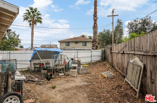 a view of a chairs and table in the backyard