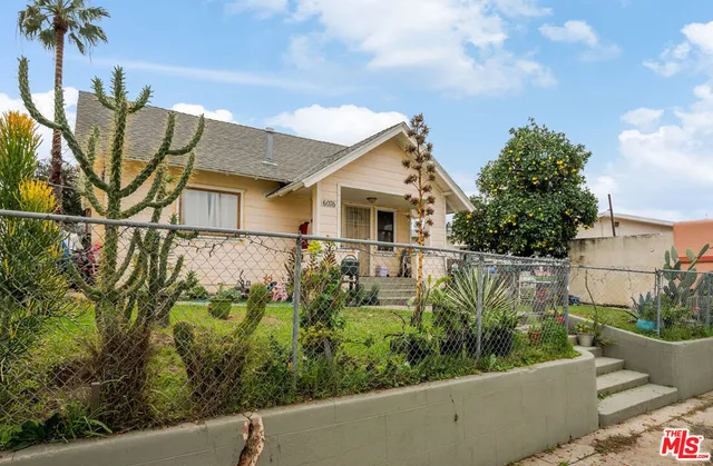 a view of a house with a small yard and plants