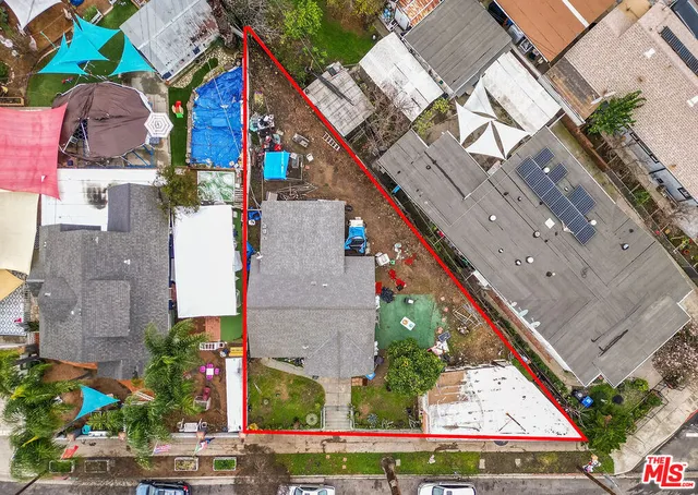 an aerial view of multiple houses with yard