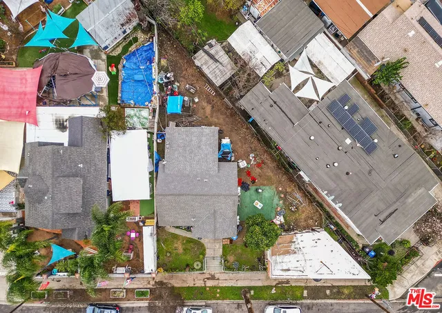an aerial view of multiple houses with yard