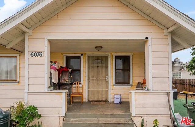 a front view of a house with a potted plant and garage
