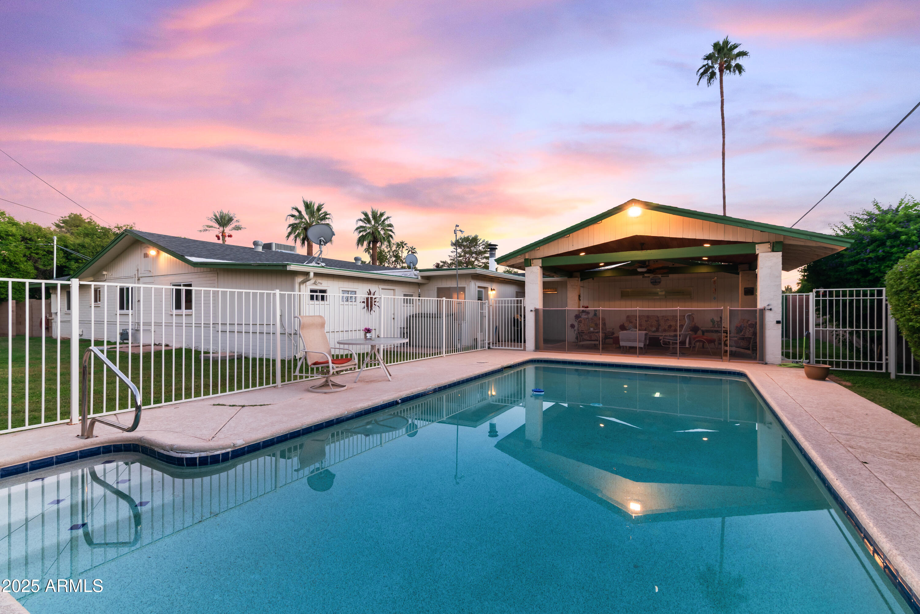 7502 North 7th Avenue Phoenix, AZ 85021 - Photo 3 of 56 a view of a patio with a table chairs and a swimming pool