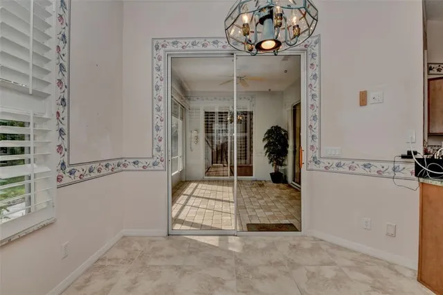 a view of a hallway with a livingroom and dining chair