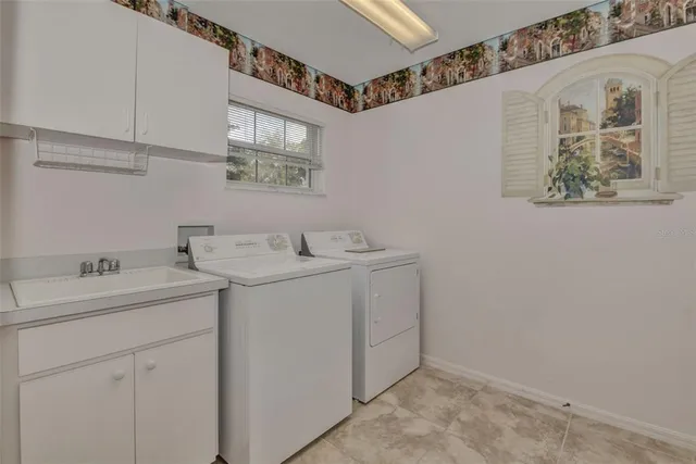 a utility room with a sink dryer and washer