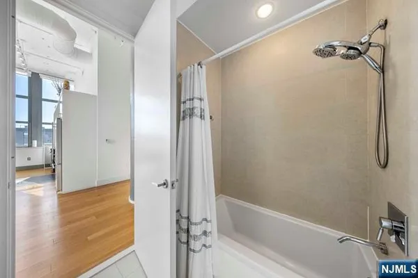 a bathroom with a bathtub and a shower