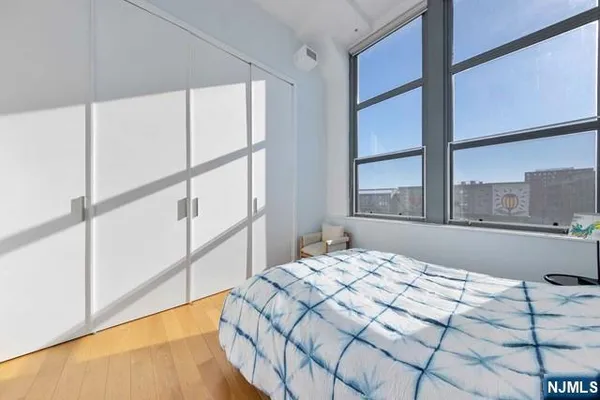 a bedroom with a bed and a large window