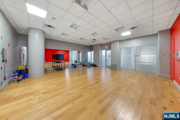 a room with gym equipment and flat screen tv