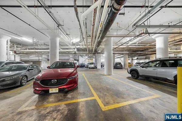 a view of parking garage with cars parked