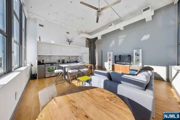 a living room with furniture and kitchen view