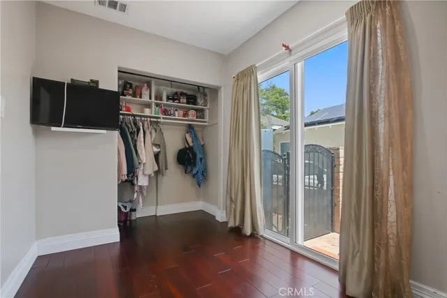 a view of a livingroom with wooden floor and a ceiling fan