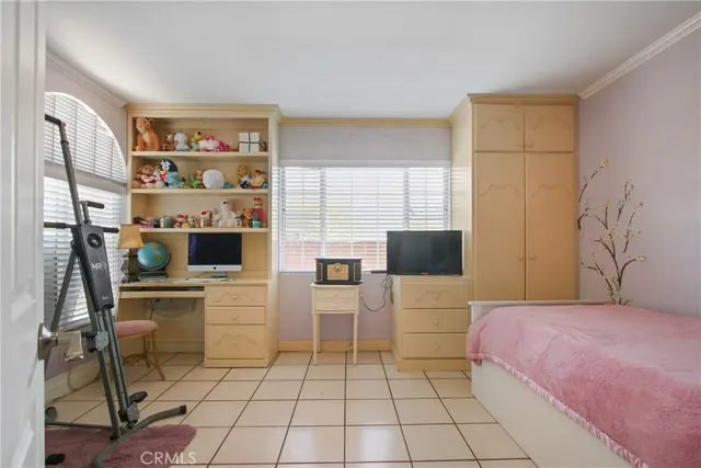 a bedroom with a bed a table and chair