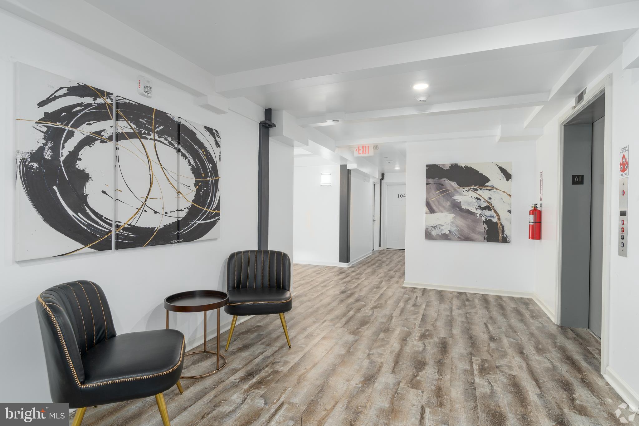 6618 Ridge Avenue, Unit 307 Philadelphia, PA 19128 - Photo 14 of 15 a living room with furniture and a mirror
