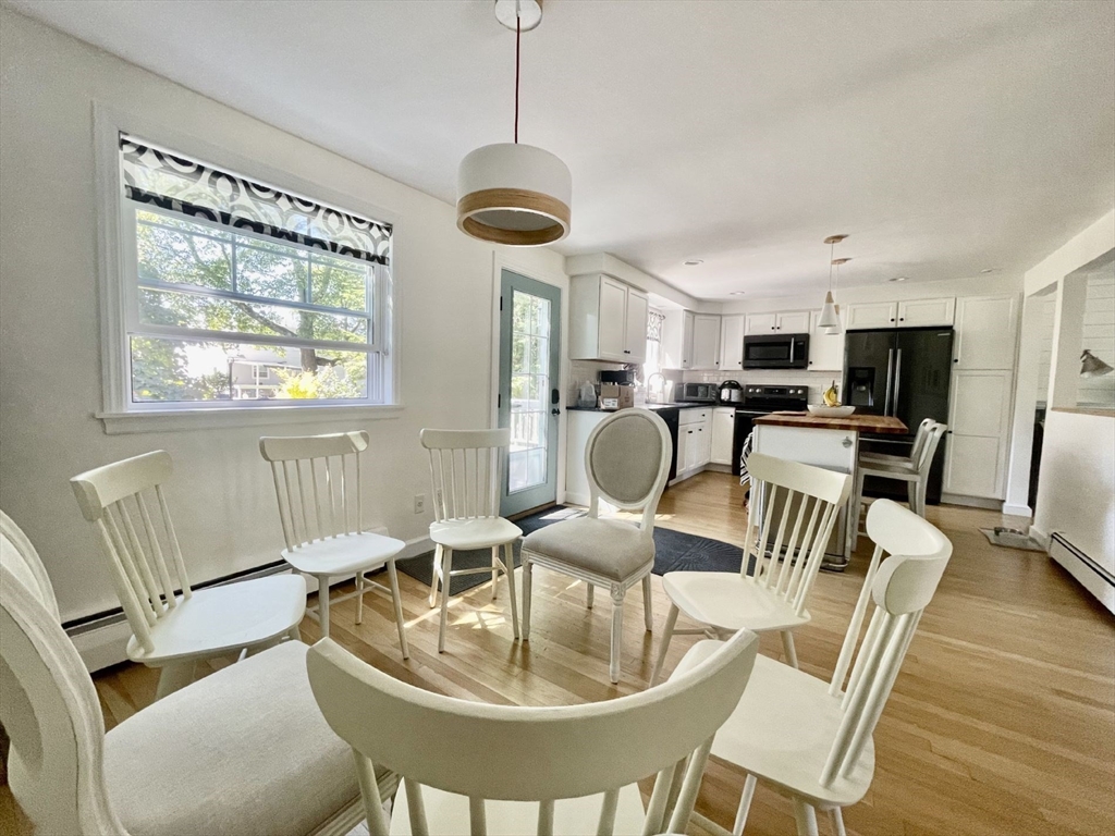 4 Carter Road Woburn, MA 01801 - Photo 11 of 28 a dining room with furniture a chandelier and wooden floor
