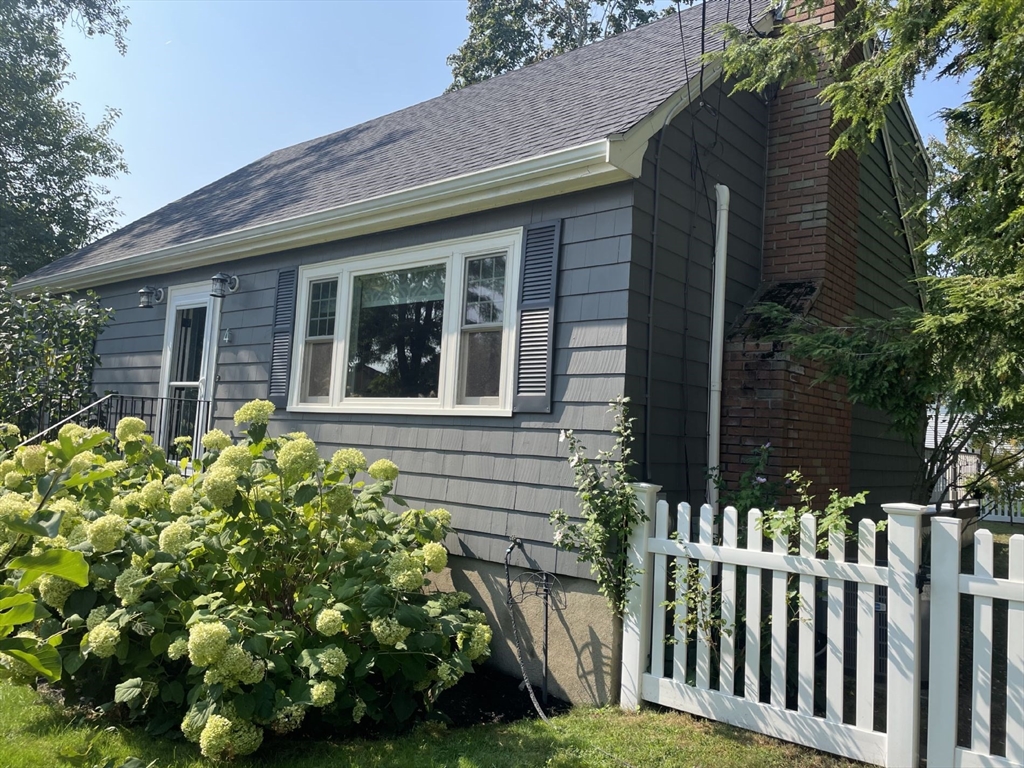 4 Carter Road Woburn, MA 01801 - Photo 2 of 28 a front view of a house with a garden
