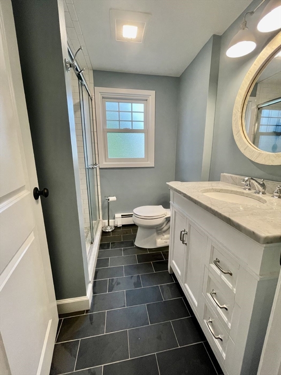 4 Carter Road Woburn, MA 01801 - Photo 21 of 28 a bathroom with a sink a toilet and a mirror