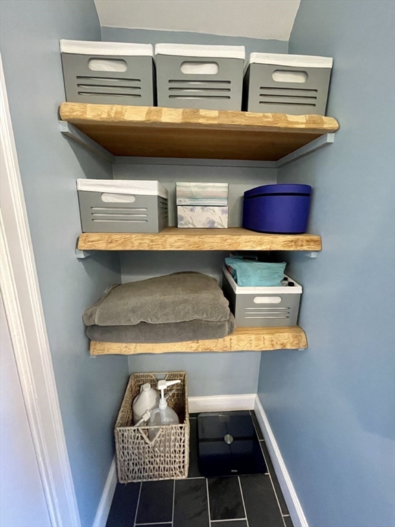 4 Carter Road Woburn, MA 01801 - Photo 22 of 28 a room with a walk in closet and a mirror