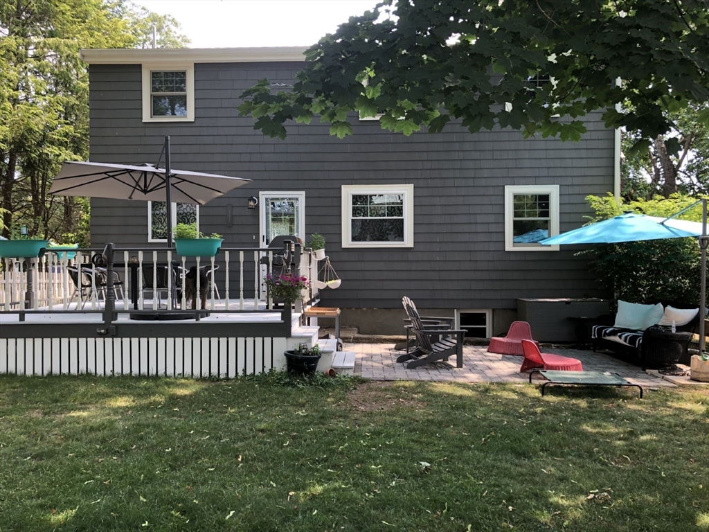 4 Carter Road Woburn, MA 01801 - Photo 25 of 28 a backyard of a house with table and chairs