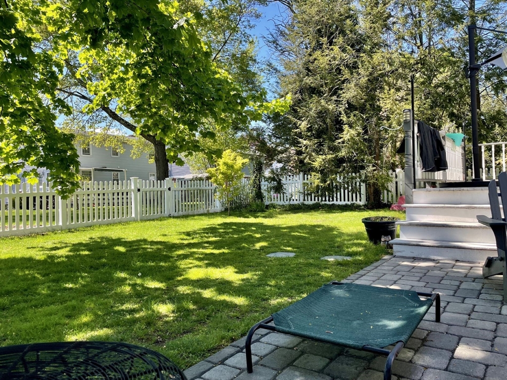 4 Carter Road Woburn, MA 01801 - Photo 26 of 28 a view of a garden with a bench