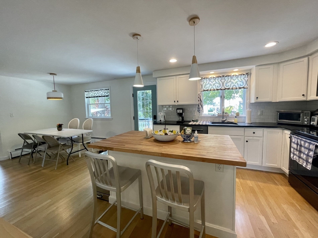 4 Carter Road Woburn, MA 01801 - Photo 7 of 28 a kitchen with sink a window and chairs