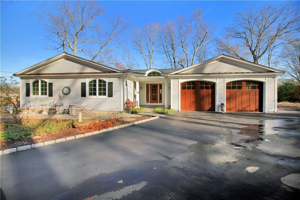 443 Springer Road Fairfield, CT 06824 - Photo 1 of 1 a front view of a house with a yard