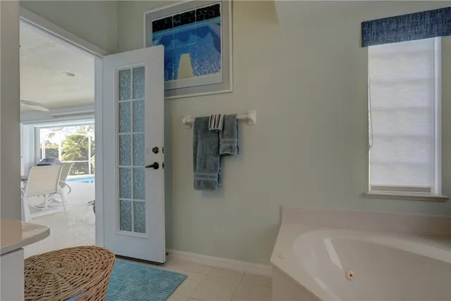 a bathroom with a tub shower and a sink