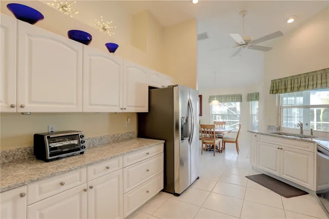 a kitchen with stainless steel appliances kitchen island granite countertop a sink and cabinets