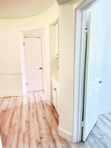 a view of a bathroom with wooden floor