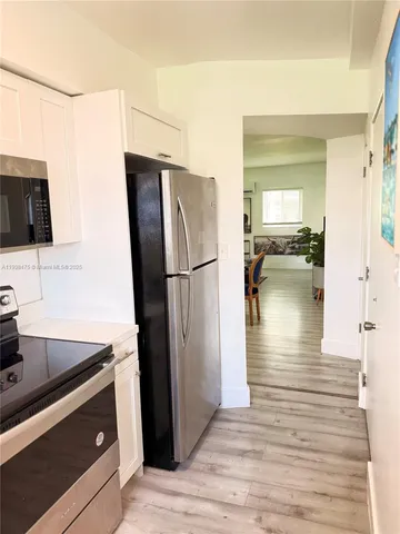 a kitchen with a refrigerator and a sink