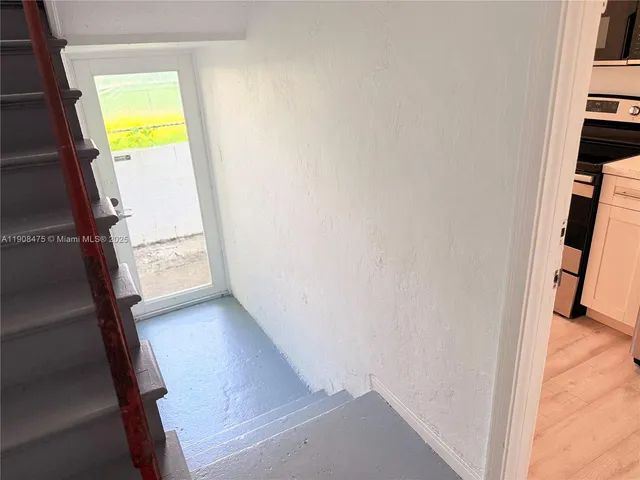 a view of an entryway with a kitchen