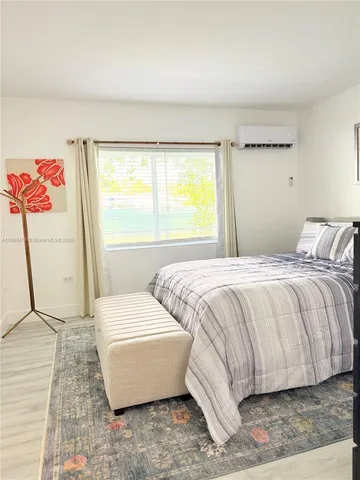 a spacious bedroom with a bed and a window