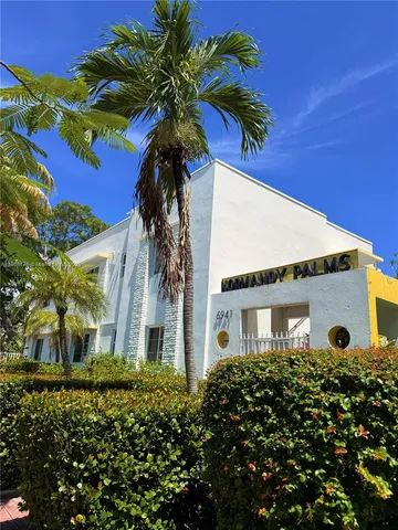 a view of a house with a flower garden